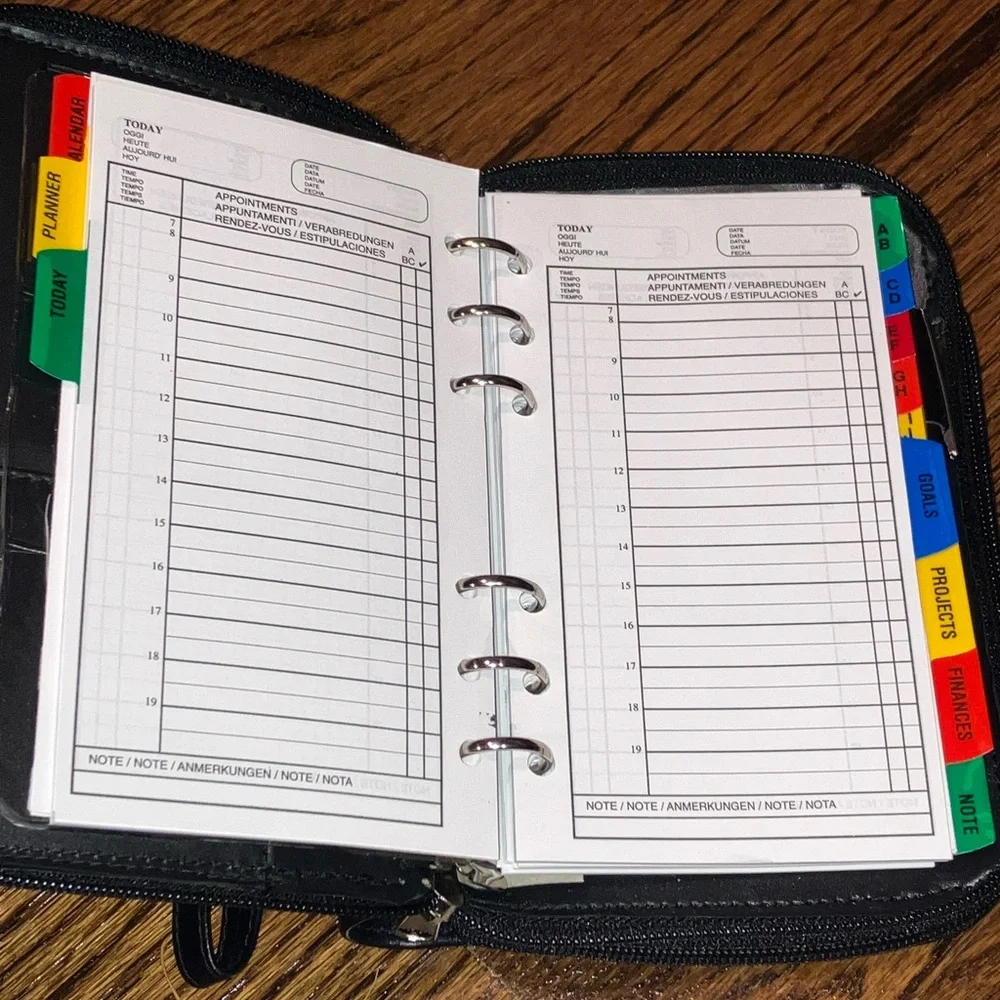 Black planner/organizer with zippered closure, wallet slot, addresses, goals